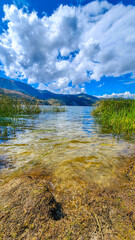 MIRROR LAKE. CLOUDS REFLECTED IN THE WATER. BEAUTIFUL LANDSCAPE OF A LAGOON. PACHUCA LAGOON. PERU TRAVEL.
