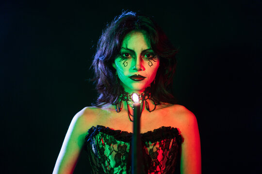 Mysterious Gothic Woman with Face Paint and Candlelight