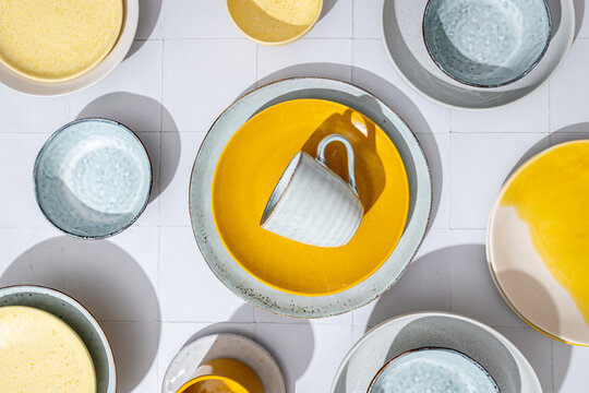 Top view of colorful artisan ceramic tableware arrangement