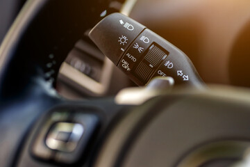 Inside the car.Car rain windscreen wiper control stickVehicle interior.Dashboard, inner workings of a car.