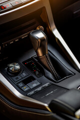 Inside the car.Gear shift handle in a modern car.Vehicle interior.Dashboard, inner workings of a...
