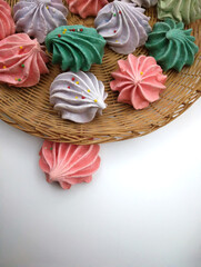 Meringue cookies in wicker basket viewed from above