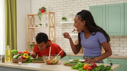African American happy family preparing food in the kitchen.