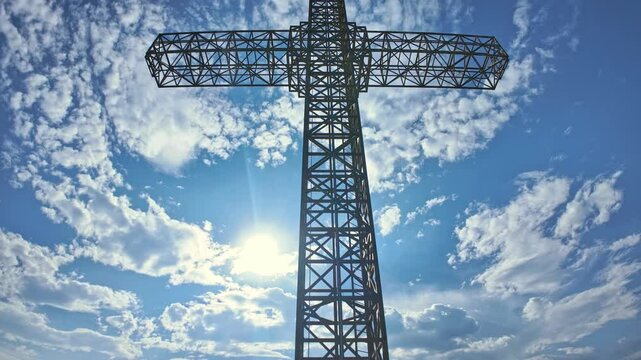 Millennium cross TIME-LAPSE in Krusevo, Macedonia. Is a large cross situated on the top of vodno mountain. Built of steel. With sun shining through the structure and a cloudy sky in the background
