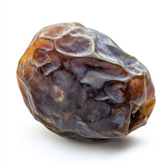 Obraz premium A single dried date, isolated on a white background, highlighting a sweet and chewy dried fruit