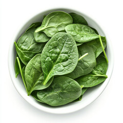 Obraz premium A bowl of fresh spinach leaves, isolated on a white background, showcasing a leafy green vegetable