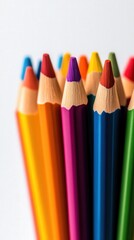 Fototapeta premium Vibrant colored pencils arranged neatly, white isolate background.