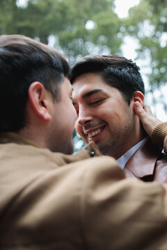 Affectionate gay couple embracing outdoors