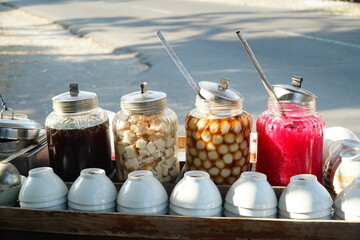 Wedang Ronde in a jar on a vendor's cart, a Javanese traditional dessert made of glutinous rice flour filled with peanut, bread in ginger syrup