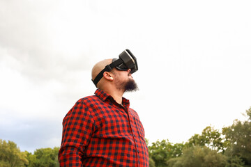 Trans man explores virtual reality in outdoor setting