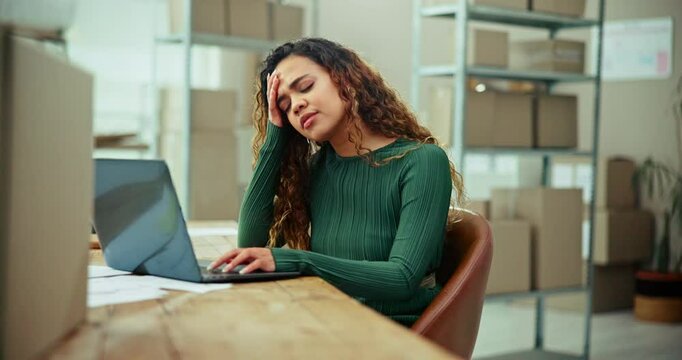 Tired woman, laptop or logistics with headache for stress, anxiety or mistake at warehouse. Frustrated, female person or distributor with migraine, glitch or tax mistake for debt or supply chain