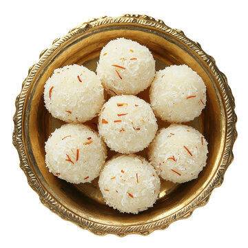Top view of Indian coconut ladoo sweets served in an ornate brass bowl isolated on transparent background.