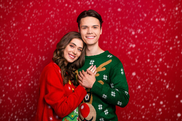 Photo of positive joyful couple wife husband hand holds arm enjoy fairy time holiday event day miracle isolated on red color background