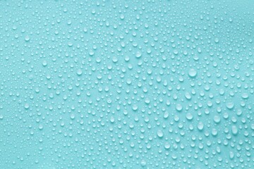 Water drops on turquoise background, above view