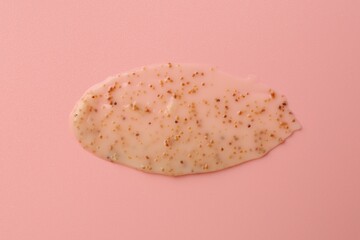 Smear of body scrub on light pink background, top view