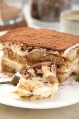 Piece of tasty tiramisu on table, closeup