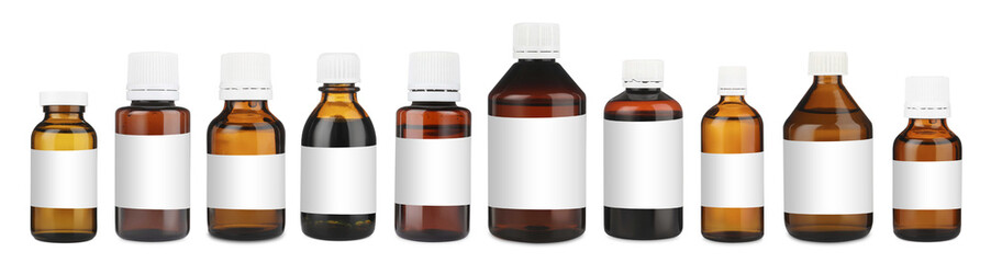 Many different glass bottles with labels isolated on white
