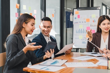 Efficient business meeting with professionals discussing data analysis and strategies. Engaged team members share insights while reviewing documents and using calculator
