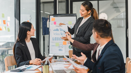 business meeting with professionals discussing marketing reports and data analysis. atmosphere is focused and collaborative, showcasing teamwork and strategy