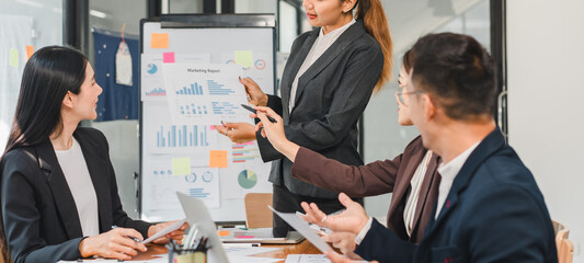 business meeting with professionals discussing marketing reports and data analysis. team is engaged and focused on presentation