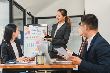 business meeting with woman presenting marketing reports to colleagues. team is engaged and discussing strategies