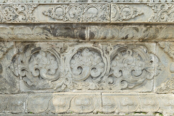 Vintage ornament on the stone. Close-up seamless texture. Stone texture. Embossed pattern.