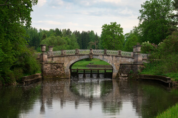 View of the Slavyanka River Valley and the Viscontiev Bridge in the Pavlovsk Palace and Park Complex on a sunny summer day, Pavlovsk, Saint Petersburg, Russia