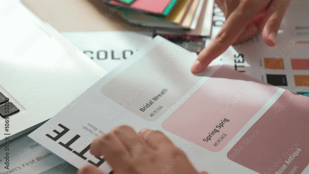 Poster slow motion hand closeup of two designer brainstorming and choosing color for graphic design working