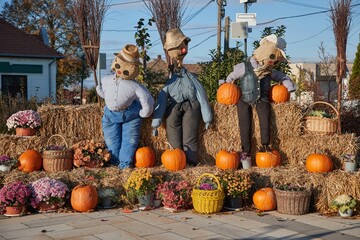 Halloween installation on a town square with pumpkins and puppets