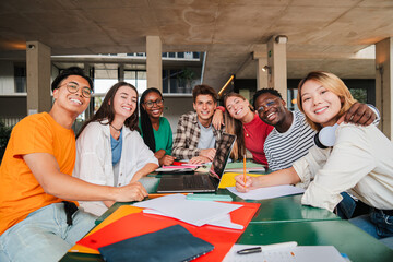 Diverse Group of University Students Share Joyful Moment During Collaborative Study Session, Their...