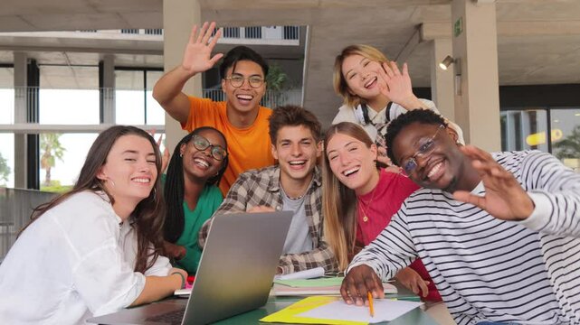 Diverse Group of University Students Share Joyful Moment During Collaborative Study Session, waving hands and doing a greeting While Working on Assignments Together on Campus