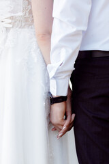 A couple in love touches each other with their hands. Love story of a young couple in love. Wedding rings on ring fingers. Concept of a marriage proposal. Starting a family.