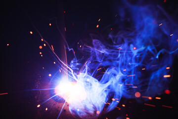 A bright flash of light and a sheaf of sparks in a cloud of smoke. Miniature Universe. Design...