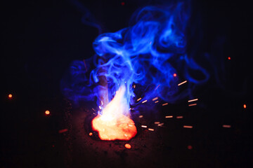 A bright flash of light and a sheaf of sparks in a cloud of smoke. Miniature Universe. Design...