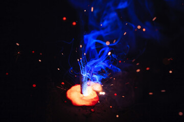 A bright flash of light and a sheaf of sparks in a cloud of smoke. Miniature Universe. Design...