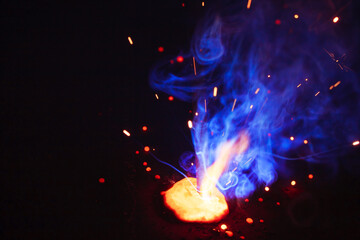 A bright flash of light and a sheaf of sparks in a cloud of smoke. Miniature Universe. Design...