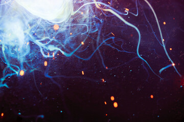 A bright flash of light and a sheaf of sparks in a cloud of smoke. Miniature Universe. Design...