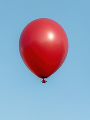 Fototapeta premium Floating red balloon in blue sky