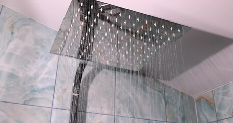 The sleek design of a rainfall showerhead adds a touch of luxury and sophistication to modern bathroom aesthetics