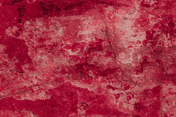 Red texture of a concrete wall with natural relief and damage in the form of chips and scratches. Fragment of an old stone surface with a crack. Dark rough surface with a place for an inscription