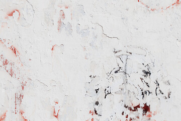 White texture of a concrete wall with natural relief and damage in the form of chips and scratches. Fragment of an old stone surface with a crack. Dark rough surface with a place for text.