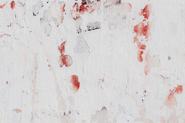 White texture of a concrete wall with natural relief and damage in the form of chips and scratches....