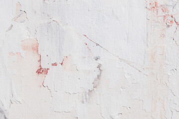 Fototapeta premium White texture of a concrete wall with natural relief and damage in the form of chips and scratches. Fragment of an old stone surface with a crack. Dark rough surface with a place for text.