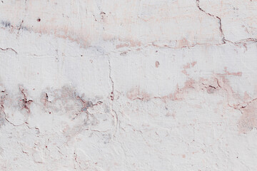 White texture of a concrete wall with natural relief and damage in the form of chips and scratches. Fragment of an old stone surface with a crack. Dark rough surface with a place for text.