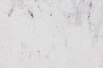 White texture of a concrete wall with natural relief and damage in the form of chips and scratches. Fragment of an old stone surface with a crack. Dark rough surface with a place for text.