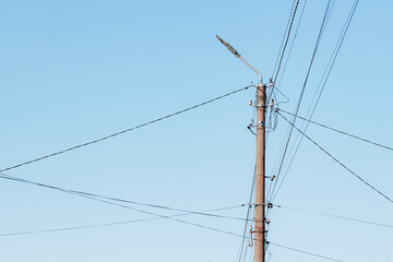 Overhead power lines. Telephone cable. Internet communications. An old post with a bunch of wires....