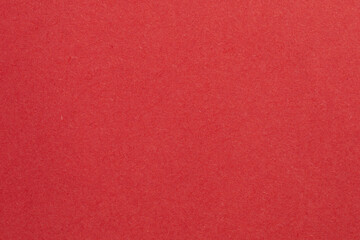 A red background with a white object in the middle, textured origami paper backdrop