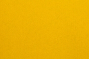A yellow background with no visible objects, textured origami paper backdrop