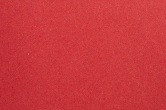 A red background with a white object in the middle, textured origami paper backdrop