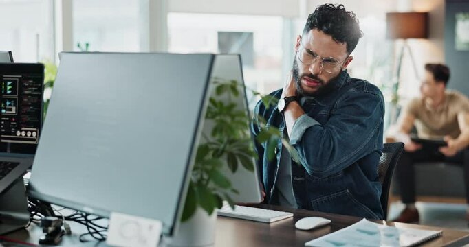 Tired, man and computer screen with neck pain in office for medical risk, website update and burnout stress. Worker, glasses and shoulder strain with IT pressure, software development and deadline